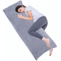 a woman is sleeping on a large pillow