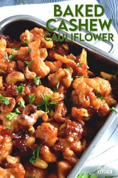 baked cashew cauliflower in a baking pan with parsley on the side