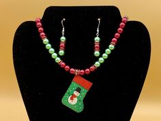 Metal snowman Christmas stocking necklace and earring set.  This will make any holiday outfit festive!  Optional matching bracelet available.  Each piece has a custom length to fit all sizes.  Necklace is made from glass pearls and crystals to form a unique and stylish look.  I can convert any of the earrings from pierced to clip on style at no charge, please request this in notes with purchase.  Please do not hesitate to contact me with any questions, I would love to hear from you. Pendant Size Metal Snowman, Set Plus Size, Holiday Outfit, Matching Bracelet, Necklace And Earring Set, Snowman Christmas, Matching Bracelets, Christmas Snowman, Christmas Stocking