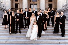 a group of people in formal wear standing on steps