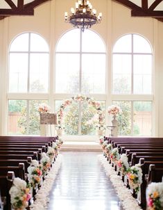 the aisle is decorated with flowers and candles