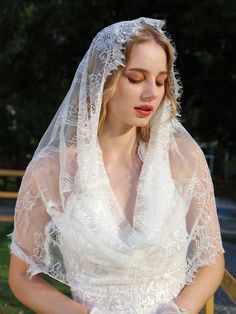 a woman wearing a white veil and dress