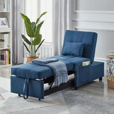 a blue chaise lounge chair in a living room