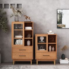 two wooden shelves with books and vases next to each other in front of a gray wall