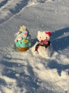 two stuffed animals are sitting in the snow