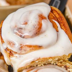 a cinnamon roll with icing in a bowl