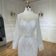 a white dress on a mannequin in a room