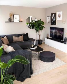 a living room filled with furniture and a large mirror on the wall above it's fireplace