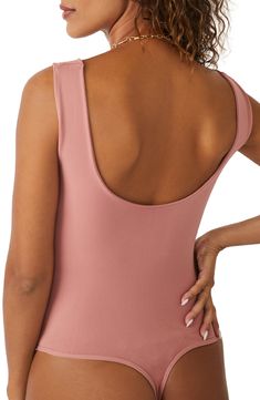 A sleek curve-hugging bodysuit featuring a dipped neckline and low U-back. Stretch fit Built-in shelf bra Snap gusset closure Thong cut 92% nylon, 8% elastane Machine wash, dry flat Imported High Stretch One-piece Leotard With Built-in Bra, One-piece Second-skin Leotard With Built-in Bra, Stretch Leotard With Built-in Bra And Scoop Neck, Solid Color Fitted Leotard With Low Back, Fitted Solid Color Bodysuit With Closed Back, Fitted Solid Color Leotard With Low Back, Sculpting Sleeveless Bodysuit For Workout, Bra Friendly Fitted Swimwear With Scoop Back, Fitted Bra Friendly Swimwear With Scoop Back