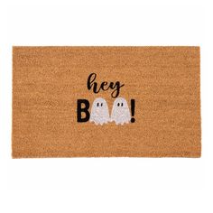 a door mat that says hey boo with two ghost faces on the front and bottom