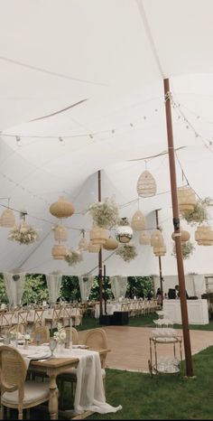 an outdoor tent set up with tables and chairs