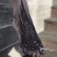 a hand with a castle tattoo on it