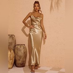 Make A Bold Statement With This Stunning Sandra Satin Backless Maxi Dress In Gold In Your Wardrobe. You'll Be Ready For What The Day Throws At You With This Dress Featuring A Scoop Neckline, Tie Straps, And A Delicately Open Back Detailing. Suitable For Going Out With Friends And Become The Most Beautiful Scenery. Material: 100% Polyester Stretch Factor: Slight Stretch Clean: Gentle Machine Wash Never Worn, Excellent Condition With Tags! Gold Fitted Sleeveless Backless Dress, Gold Fitted Backless Dress For Date Night, Gold Sleeveless Backless Dress For Date Night, Gold Backless Maxi Dress For Night Out, Gold Spaghetti Strap Midi Dress, Gold Sleeveless Backless Dress, Elegant Gold Midi Dress With Spaghetti Straps, Gold Satin Maxi Dress For Date Night, Gold Fitted Sleeveless Slip Dress