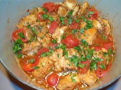 a pan filled with meat and vegetables covered in sauce