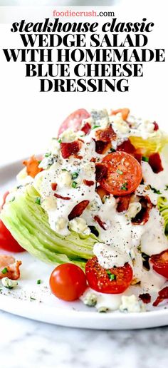 a salad with lettuce, tomatoes and dressing on it in a white plate