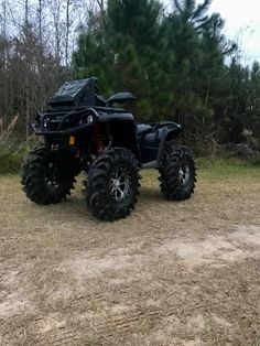 a black four - wheeler parked in the middle of a field