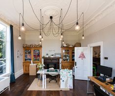 a living room filled with furniture and lots of windows