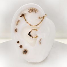 an assortment of jewelry is displayed on a white surface, including ear rings and necklaces