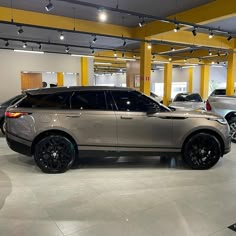 a range rover parked in a showroom with other cars