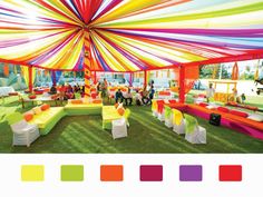 an outdoor event with colorful tents and tables set up for a party or wedding reception