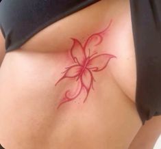 a woman's stomach with a flower tattoo on it