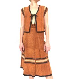 "Amazing vintage 1970s brown suede two piece vest and skirt outfit. Perfect with a long sleeve patterned blouse for fall!  Measurements:  Top:  Bust: Up to 38\" Length: 19\"  Bottom:  Waist: 24\" Hip: 42\" Length: 29\" Modern Size: XS-S All measurements are taken with the garment laid flat.  Excellent Vintage Condition.  All items at Time Warp are vintage, so there is some wear. They may not be 100% free of minor defects, as they have already been loved. We list items by condition and note any f Vest And Skirt Outfit, 70s Prairie Dress, 70s Prairie, Prairie Dresses, Thrifted Clothing, Western Skirts, Boho Vest, Embroidered Tunic Dress, 70s Outfits