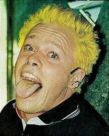 a man with yellow hair sticking out his tongue