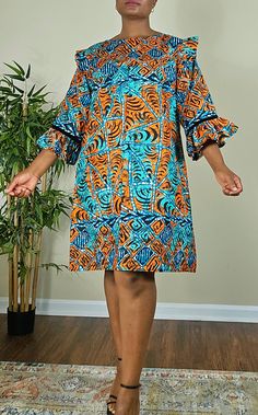 This beautifully crafted kaftan dress features a colorful colorblock pattern, with asymmetrical Ruffles sleeves and a unique button accent. The dress has a round neckline and is closed with a button, making it perfect for a variety of occasions such as travel, weddings, parties, casual or formal events, and workwear.  The dress is made from high-quality polyester material, which is machine washable for easy care. It's available in size M, and L and is handmade, perfect for women who appreciate u African Dress Patterns, Ruffles Sleeves, Puff Sleeves Dress, Button Making, Short African Dresses, Ankara Gown, Ankara Gown Styles, Gown Styles, Maternity Outfits