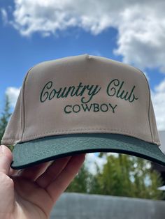 Calling all cowgirls! Elevate your style with our Country Club Cowboy Trucker Hat. Featuring an embroidered western graphic, this trendy hat is the perfect accessory to complete any casual outfit. Perfect for spring and summer, wear it to concerts and festivals for a chic and fashionable look. Available in 2 colors! Twill cap Made in USA Embroidery at front and side panel Adjustable back strap Brim measures approx 3" in lengthOS measures approx 23.55" in circumference Retro Snapback Hats For Country Events, Vintage Snapback Trucker Hat For Country Events, Vintage Rodeo Baseball Cap With Curved Brim, Vintage Curved Brim Baseball Cap For Rodeo, Western Style Adjustable Baseball Cap For Summer, Snapback Baseball Cap For Rodeo In Summer, Vintage Snapback Hat For Rodeo, Vintage Snapback Rodeo Hat, Retro Snapback Hat For Outdoor Use In Spring