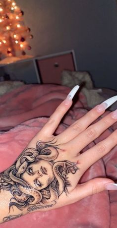 a woman's hand with a tattoo on it