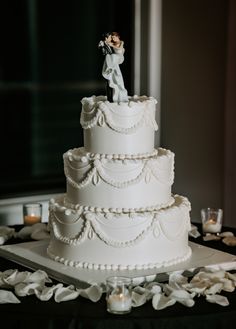 a wedding cake with a figurine on top