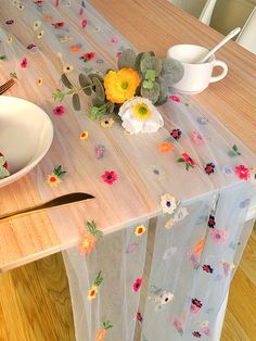 a table topped with a white plate covered in flowers