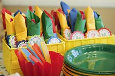 there are many different colored plates and cups in this tableware set up with each other