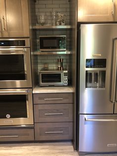 a kitchen with stainless steel appliances and cabinets