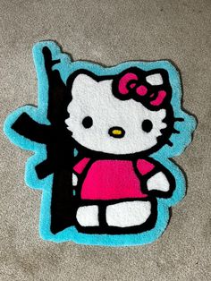 a hello kitty sticker on the ground in front of a carpeted floor area