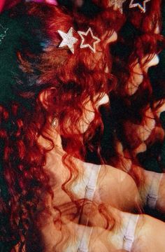 two women with red hair and three silver stars in their hair