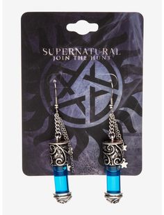 pair of earrings with blue glass beads and silver chain on the end, in front of a