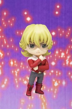 an anime figurine with blonde hair and blue eyes, standing on a purple background