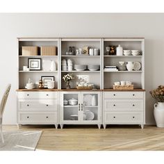 a white bookcase with lots of dishes on it