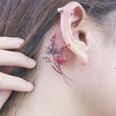 a close up of a person's ear with flowers on it