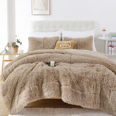 the bed is made with fluffy fur and pillows