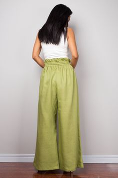 "Green Linen trousers, Handmade long wide leg palazzo pants with pockets. Green high waist women's summer linen pants, natural linen pants Made with the highest care this beautifully crafted high waist women's summer pants will fit you perfect thanks to the elastic strap on the waist and the added drawstring. I like wearing this one when sitting in the garden reading a book and dream away. Soul of the Orient Collection - Original Design & Produced by NUICHAN PRODUCT SIZE : * Waist : elastic Summer Ramie Bottoms, Baggy Wide Leg Vacation Pants, Linen Wide-leg Pants For Vacation, Vacation Linen Wide-leg Bottoms, Bohemian Summer Pants In Solid Color, Non-stretch Linen Beach Bottoms, Baggy Wide-leg Summer Bottoms, Summer Baggy Wide-leg Bottoms, Baggy Wide Leg Pants For Beach In Summer