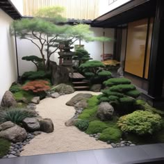 a japanese garden with rocks, grass and trees in the center is displayed on display