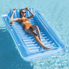 a woman laying on an inflatable pool float