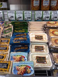 an assortment of frozen food on display in a grocery store's deli case