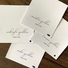 four envelopes with calligraphy on them sitting next to each other and one has a dog