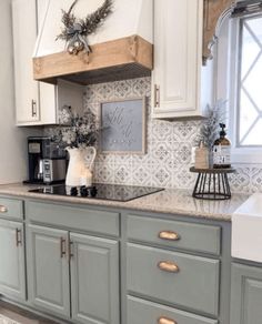 a kitchen with gray cabinets and white walls