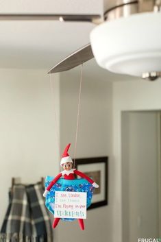 an ornament hanging from the ceiling with a santa hat on it