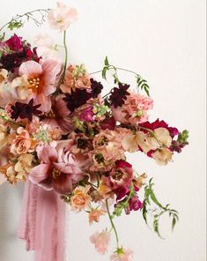 a bouquet of flowers is hanging on the wall