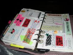 an open planner book sitting on top of a bed